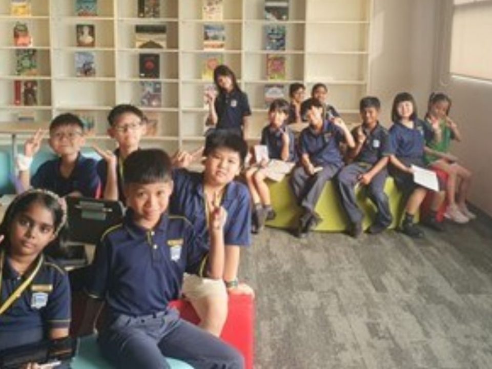 Primary school students immersed in joy and learning during an exciting lesson at the library.