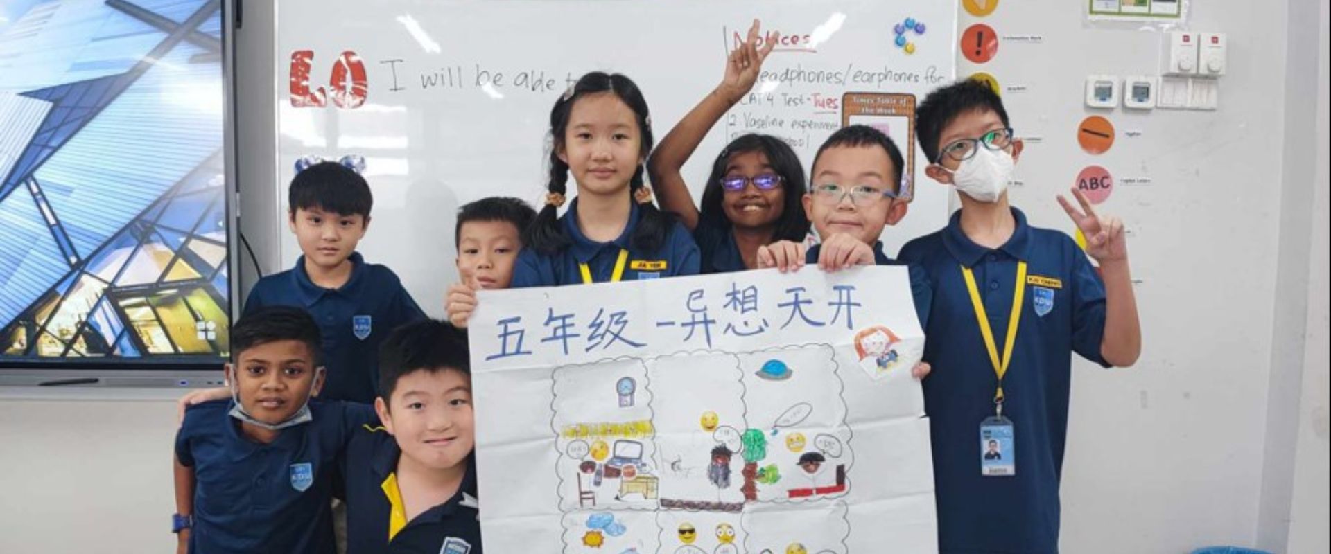 Primary school students proudly display their collaborative artwork, showcasing creativity and teamwork in action.