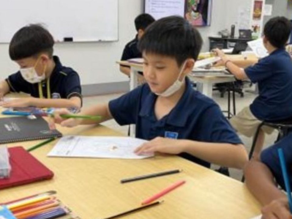 Primary school students engaged in learning activities within the classroom environment.