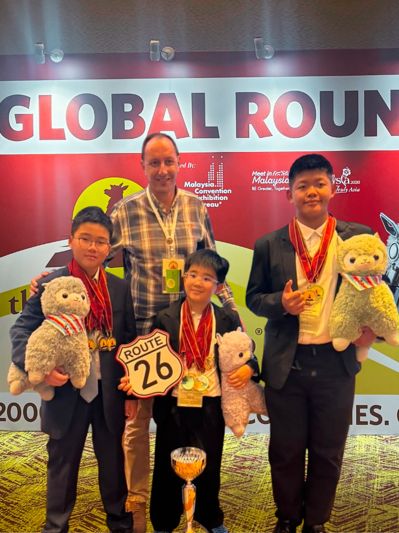 Ian Hopkins and the three scholars at the Global Rounds of the World Scholars Cup 2026