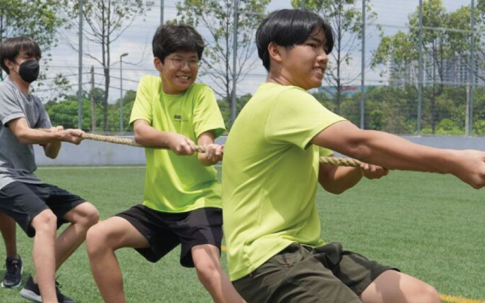 Secondary School students engaging in a Tug of war sport at the football pitch