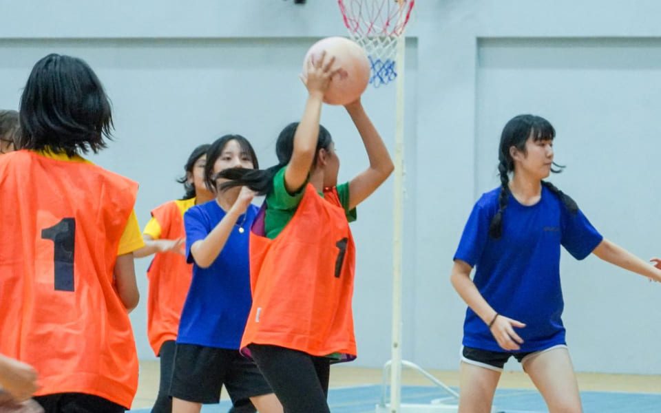 Female students engaging in friendly volleyball game