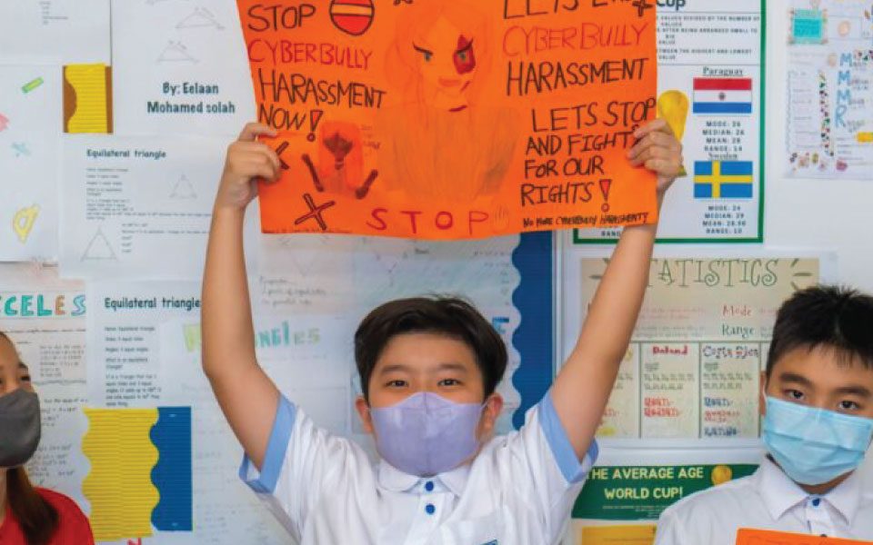 Secondary school students working in groups to design campaign poster during their project based learning activity