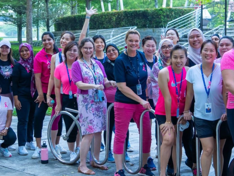 Parents, teachers, and staff unite in a morning walk to raise awareness for breast cancer, demonstrating solidarity and support for the cause.